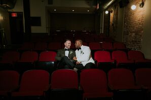 Grooms in White and Green Suit Jackets Sitting in Vintage Movie Theater Seats