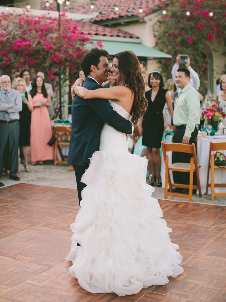 Bride and groom slow dancing on the dance floor. 
