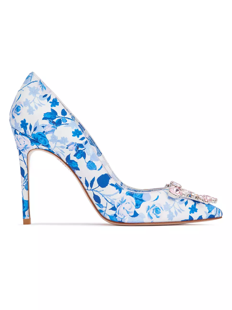 White pump with floral accents in blue with a sparkling buckle on the front