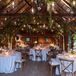 Barn Reception With Hanging Greenery and Light Bulbs, Round Tables With White Linen, Candles