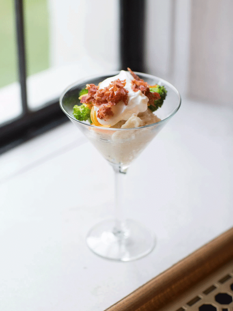 Mashed potato with toppings in a martini glass. 