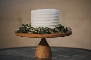 Single-Tiered Wedding Cake with Wooden Stand and Greenery