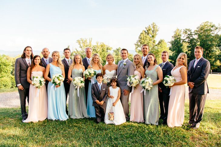 Jeff wore a custom light gray tuxedo and his groomsmen wore slightly darker Calvin Klein tuxes with ties that matched the pastel tone of the bridesmaid they were walking with.