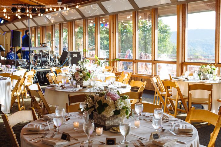 Draped fabric and hanging cafe lights softened the wood and burlap decor. 

