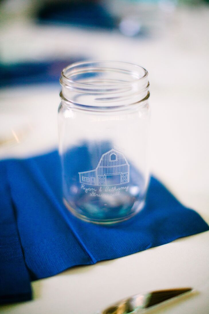 These custom mason jars served a dual purpose. Guests used them to serve themselves beer and wine during cocktail hour. Later at the reception, more mason jars were set at each place setting for guests to use at dinner and then take home as a wedding favor.