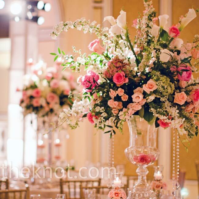 The couple's florist created tall centerpieces with sweet pink florals and hanging crystals.
