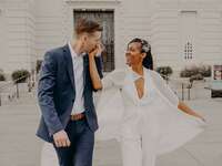 groom kissing bride's hand as they walk together
