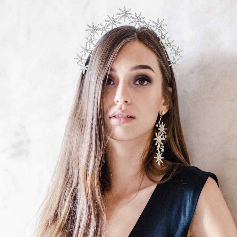 Model wears a tiara that features beautiful embellished stars. 