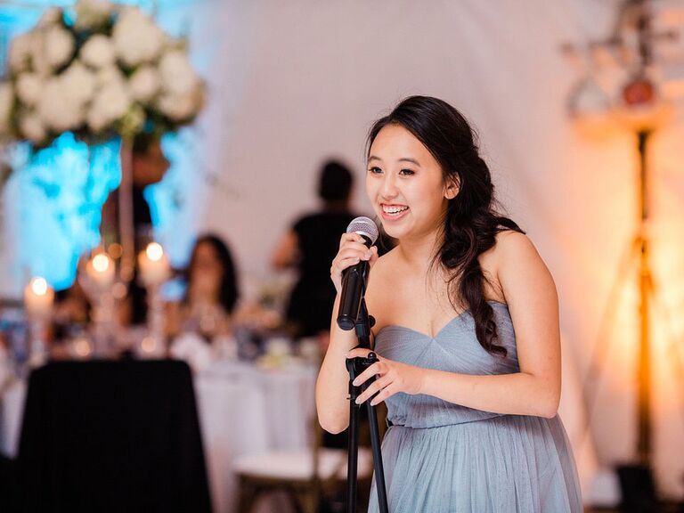 Maid of honor giving speech at wedding reception