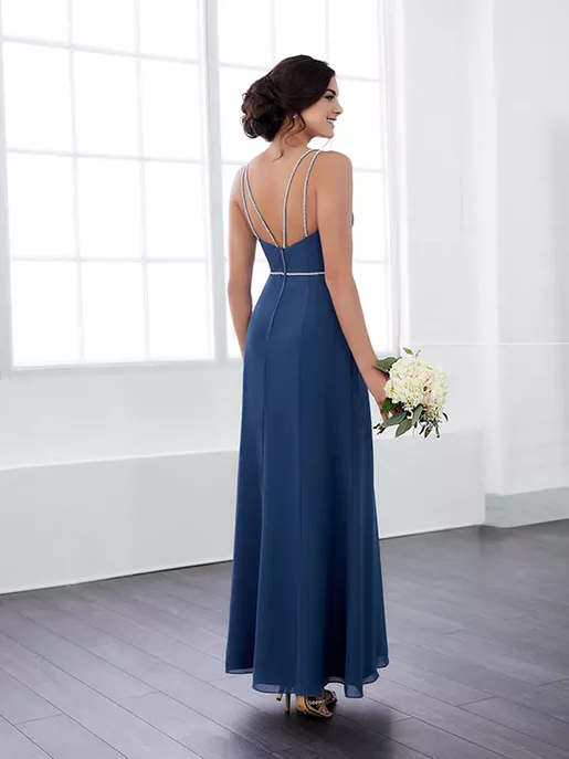 A model shows off the jeweled back of a navy blue bridesmaid dress.