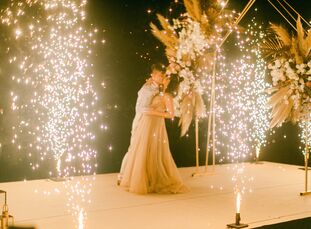 For Suki and Sing's "boho luxe" wedding in Phuket, Thailand, the couple chose an earthy color palette with metallic accents threaded throughout. A, "m