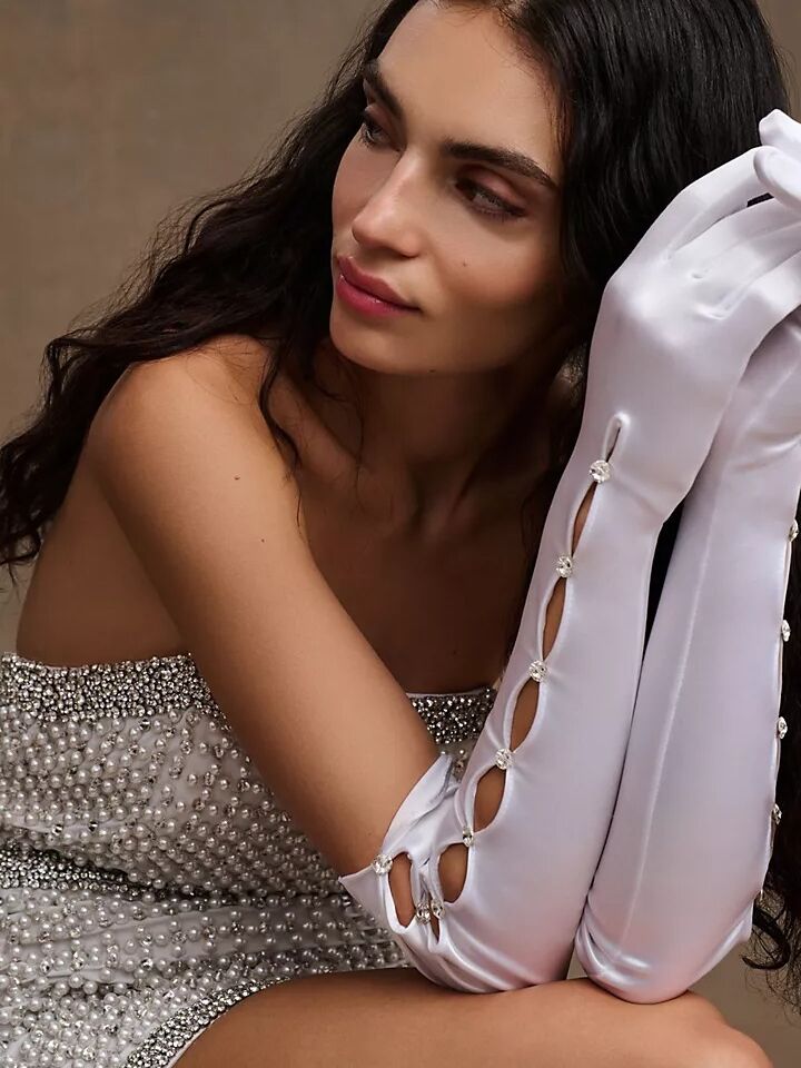 Elbow-length white satin gloves with a cut-out detail and clear gems from Anthropologie