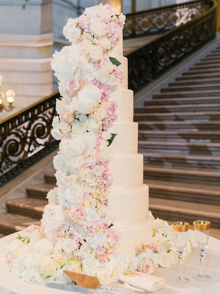 luxury seven tier wedding cake with white fondant and pink and white flowers