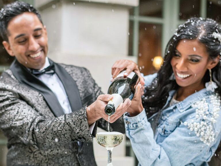 Couple pouring celebratory champagne