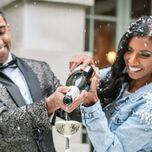 Couple pouring celebratory champagne