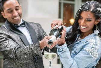 Couple pouring celebratory champagne
