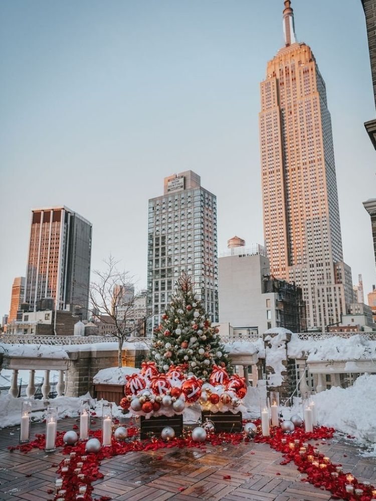 Snowy Christmas wedding proposal in New York City with Christmas ornaments