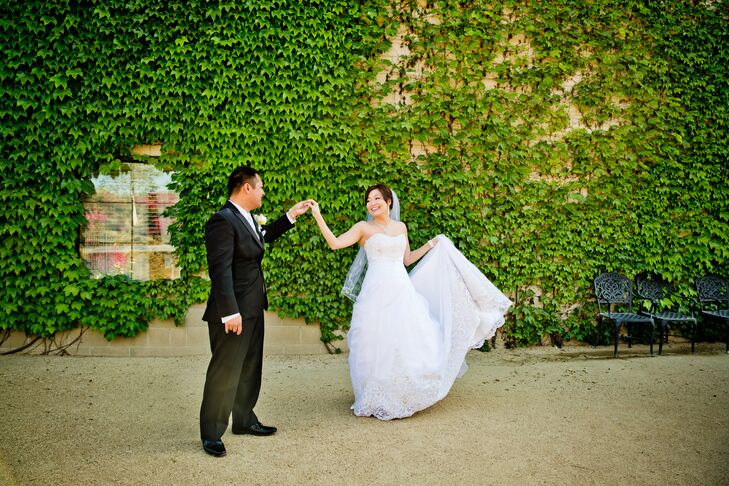 Rainnier twirled Joanne around in her white strapless A-line Alfred Angelo dress, which had lace accents on the bodice and trim of the long train.