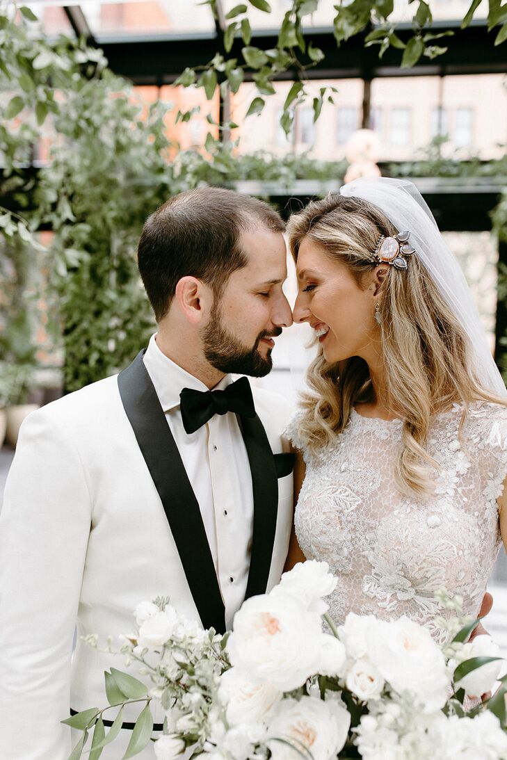 Groom in Black-and-White Tux With Bride Wearing Veil