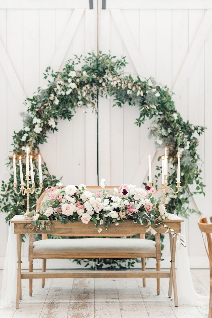 Romantic Sweetheart Table with Candelabras, Floral Arrangement and Wreath Backdrop