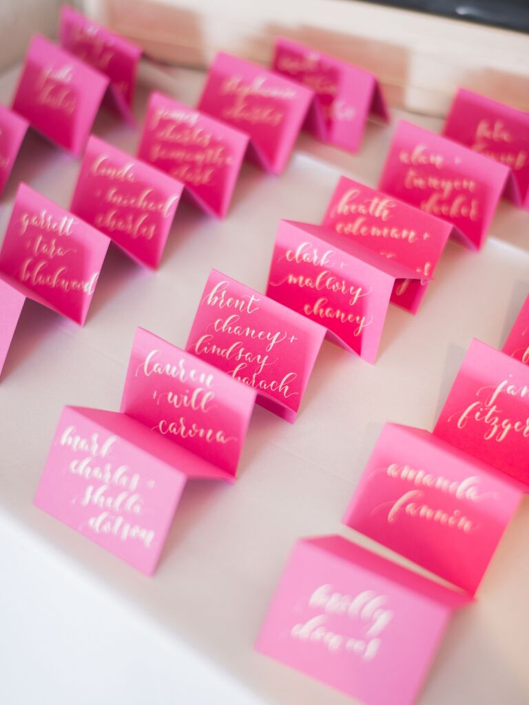 viva magenta wedding escort cards with gold calligraphy