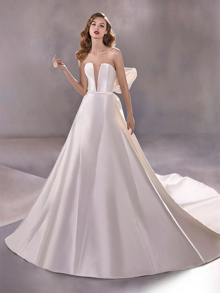 Atelier Provonias wedding dress plunging ball gown with detachable back bow