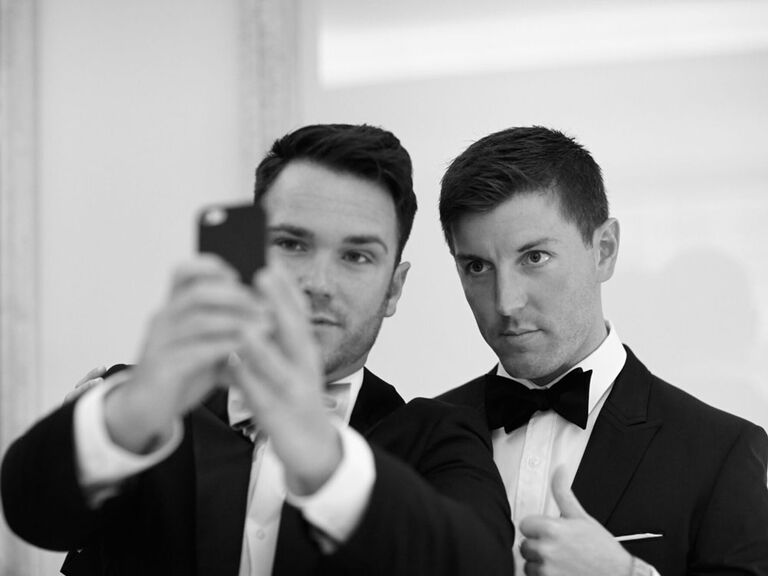 Groomsmen taking selfie on wedding day
