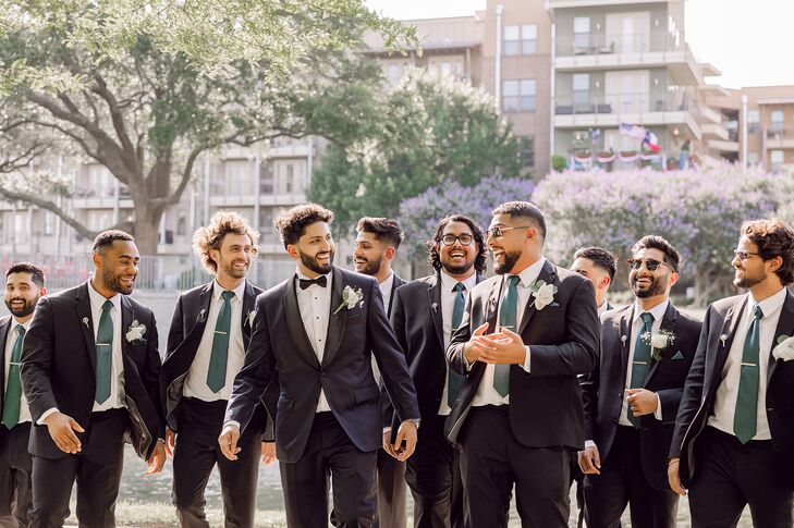 Groom in Dark Navy Tuxedo and Groomsmen in Matching Suits With Blue Ties Laughing