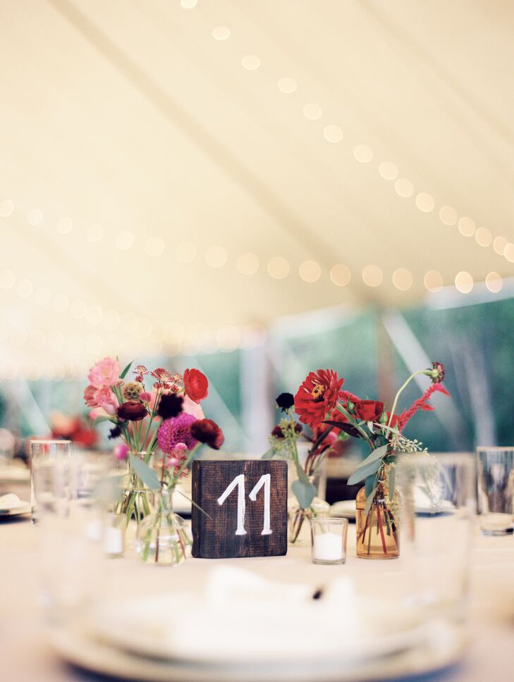 To capture the wedding’s free-spirited feel, Moonstone & Moss filled vintage-inspired bud vases with small bouquets of seasonal blooms in shades of red, purple and pink. The petite bundles were offset by eucalyptus accents that gave the centerpieces a fresh scent and a cool contrast.