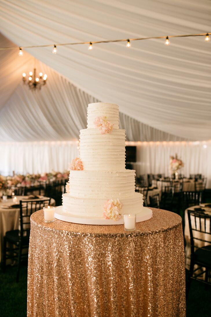 Guests enjoyed the wedding cake, made by Cookie Basket, which consisted of four layers and flowers as decoration.