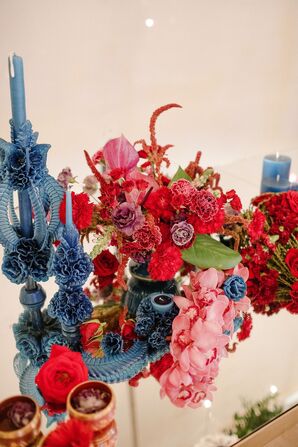 Blue Taper Candles and Red Flower Arrangement