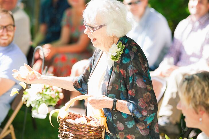 At the ceremony, the couple had their grandmothers be the "flower grandmas," tossing white gardenia petals down the aisle from a wooden basket. Doug's grandfather was the ring bearer. The couple wanted to make sure they celebrated their loved ones, so they incorporated their families into the wedding ceremony as much as possible.