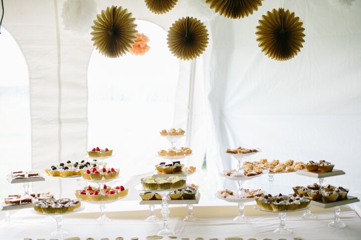 Cupcake Dessert Table and Gold Paper Pom Poms at Tented Backyard Reception