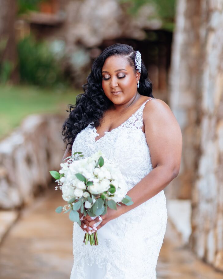 Bride Posing Outside Castle Venue, Fitted Wedding Dress, White Floral Bouquet, Down Hairstyle With Hair Clip