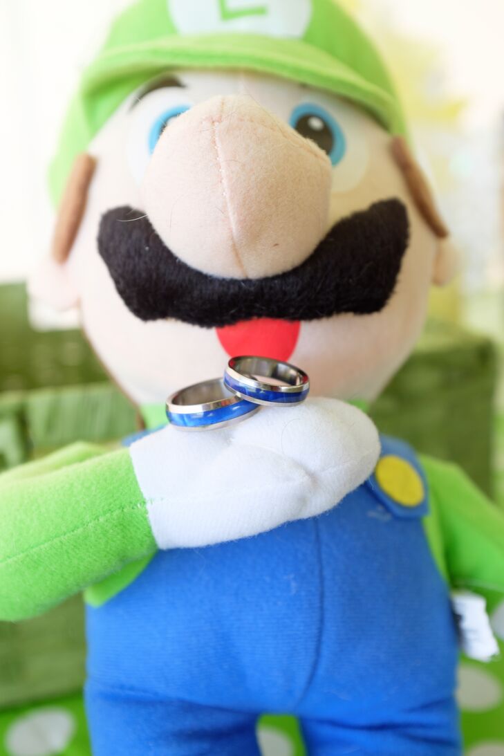 The couple displayed their rings on an adorable Luigi plush doll.