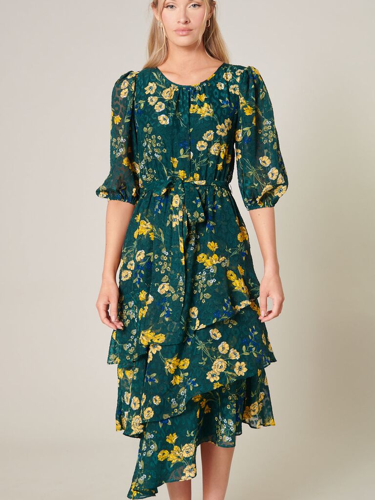 A green, yellow, and blue tiered floral dress with puffed mid-sleeves from Sugarlips