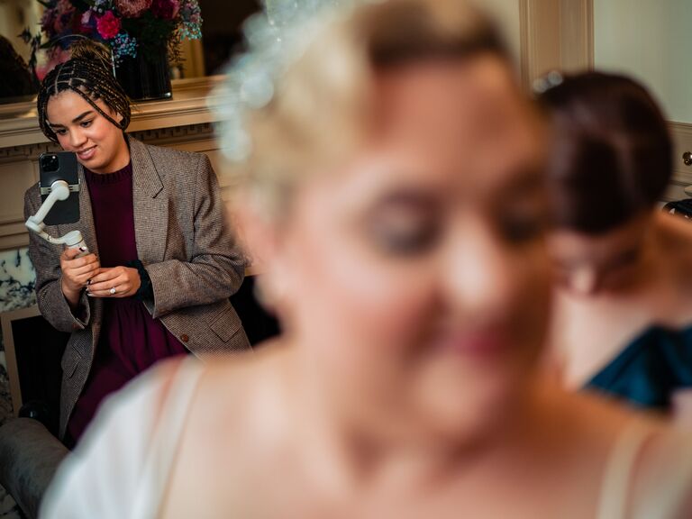 Wedding content creator capturing footage on wedding day