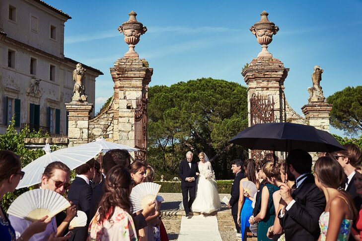 Centuries-old cypress and dramatic medieval architecture set the tone for the outdoor ceremony. Because of the unseasonably warm temperatures, guests were given fans and umbrellas to use during the outdoor ceremony.