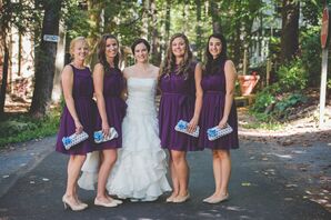 Bridesmaids Dressed in Plum Cocktail Dresses with Light Purple and Blue Clutches