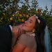 Groom Embraces Bride in Gold Headpiece, Gold Statement Earrings, Low-Back Outfit at Sundown
