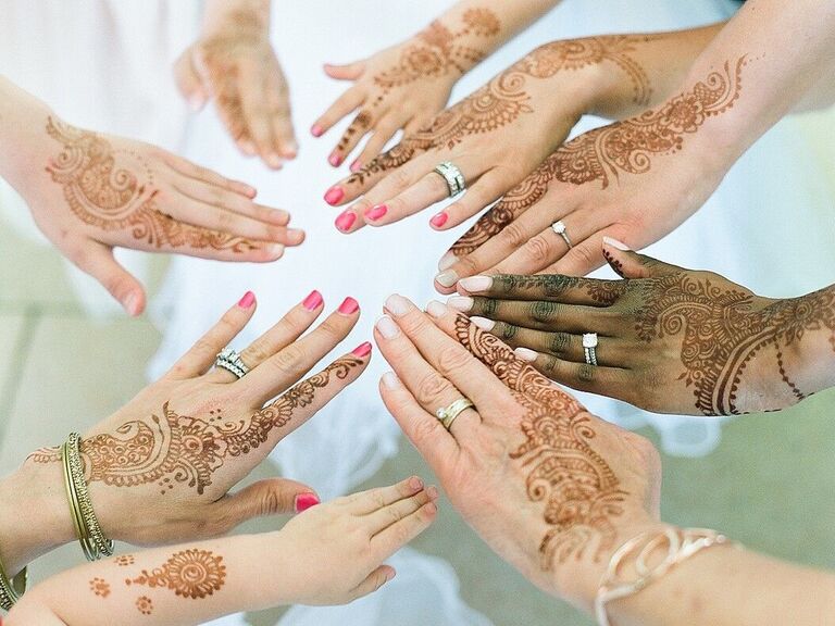 Women with hands in circle showing off engagement and wedding rings