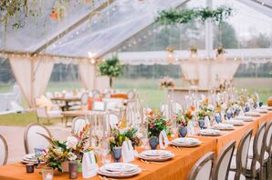 Rustic Tented Wedding Reception With Orange Linens and Blue Water Goblets