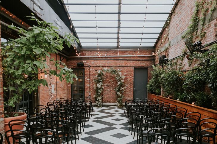 Industrial, Vintage-Inspired Ceremony Space With Exposed Brick, Vines and String Lights