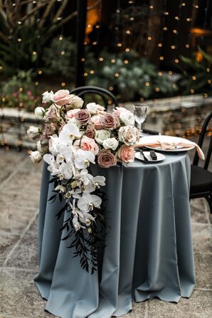 Sweetheart Table With Blue Linen and Dramatic Floral Arrangement