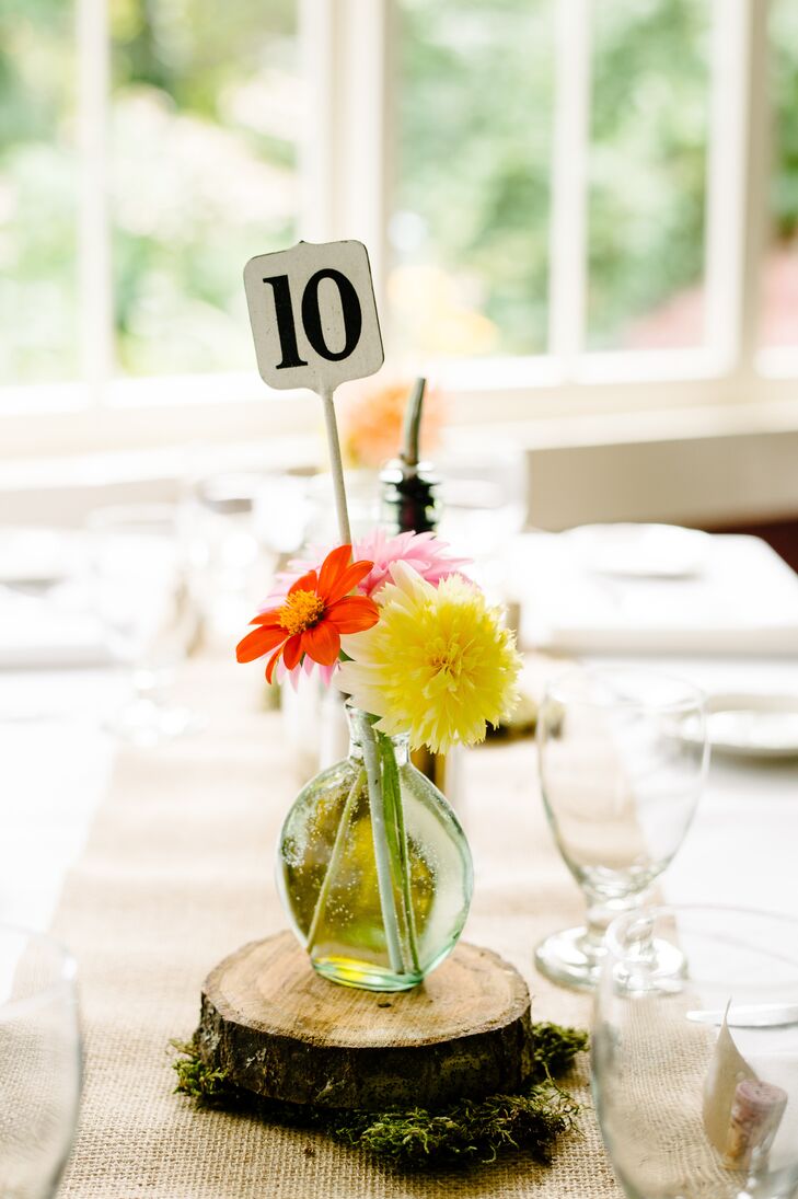 Playing up the rustic, natural theme, the restaurant's tables were topped with lengths of burlap and bright floral arrangements atop moss-covered tree slices.