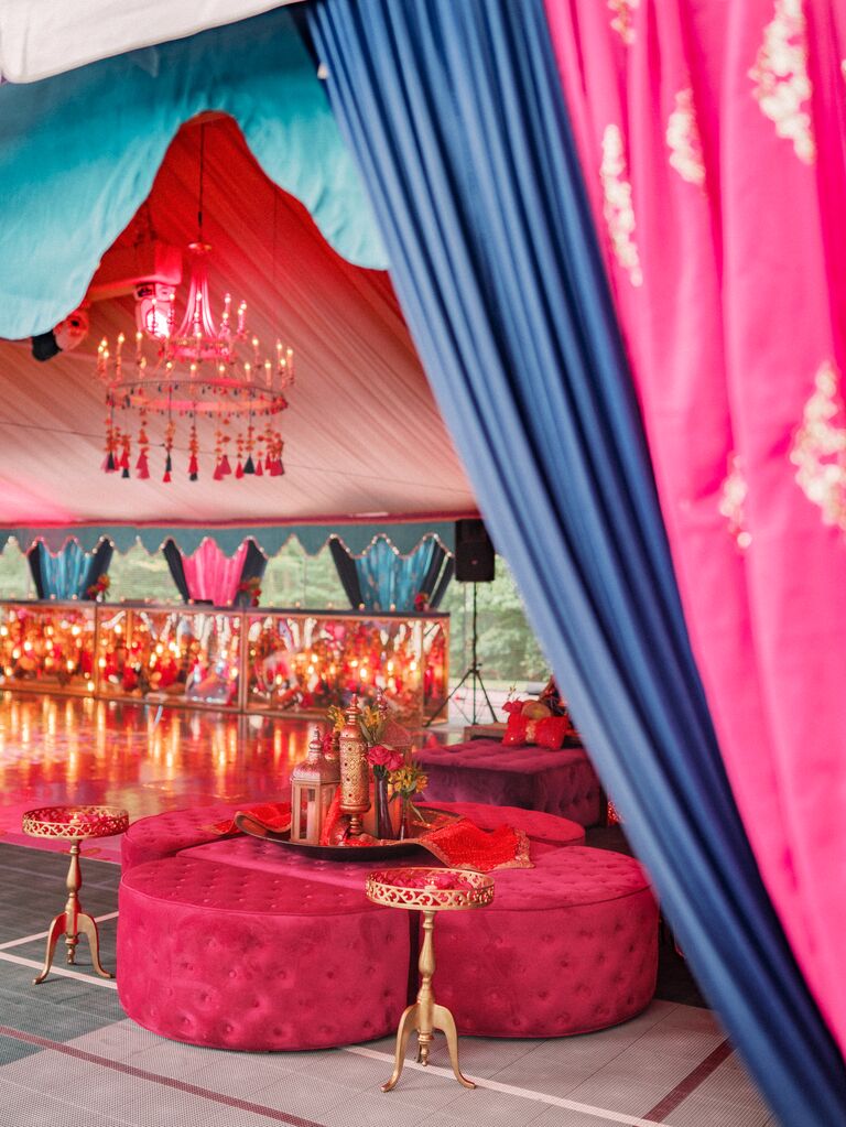 wedding lounge decorated with drapery and furniture in 2023 wedding colors, hot pink purple and turquoise