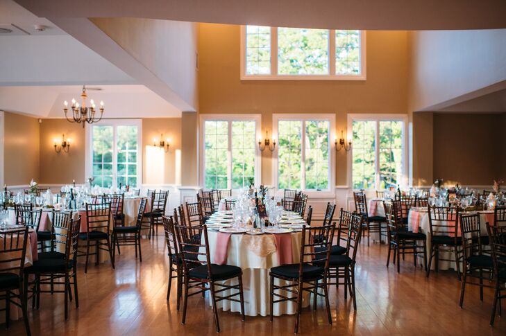 A mix of romantic and natural decor covered the Rock Island Lake Club for their Sparta, New Jersey, reception. Ivory linens and dusty rose napkins marked each oval or round table. Organic moss and low arrangements of pink roses served as centerpieces alongside colored glass votives and various vintage-style trinkets. The mixed designs nodded to their natural ceremony setting.