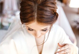 bride in robe looking down