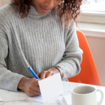 Writing wedding wishes in a wedding card to say congratulations