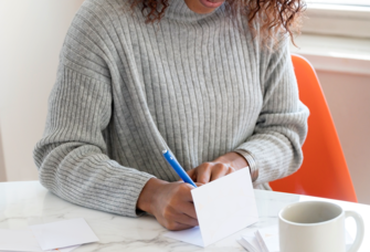 Writing wedding wishes in a wedding card to say congratulations